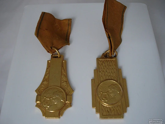 Couple medals. Golden metal. 1950's. Awards music. Women