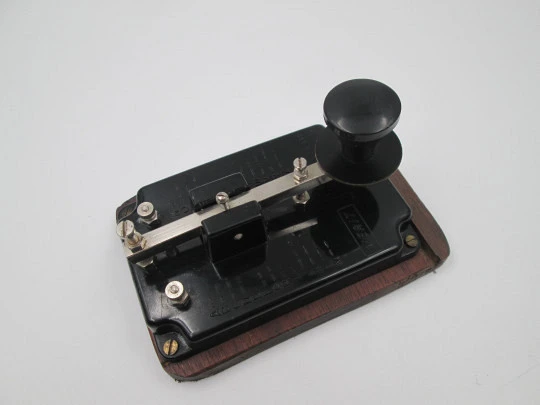 Merit morse code key with alphabet. Black bakelite and wood stand. England. 1950's