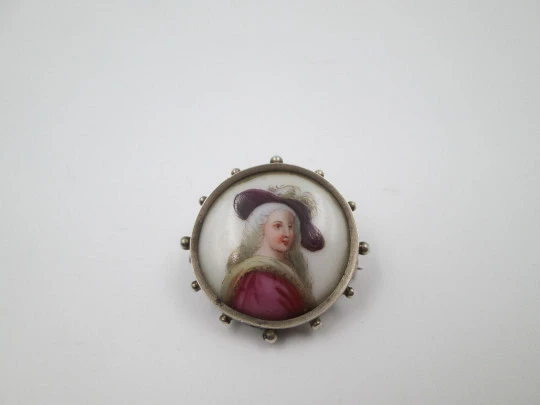 Painted porcelain and sterling silver brooch. Eighteenth century woman. Balls edge. 1940's