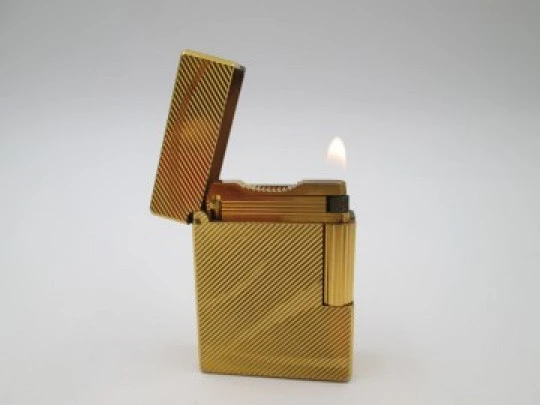 S.T. Dupont lighter. Gold plated metal. Lines pattern & anagram. 2001