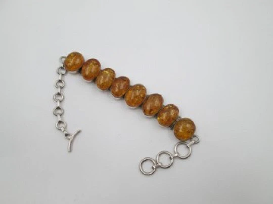 Women's articulated bracelet. Sterling silver & amber. Toggle clasp. 1980's