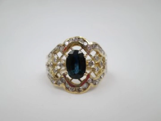 Women's openwork ring. 18 karat yellow gold, diamonds and sapphire. Europe