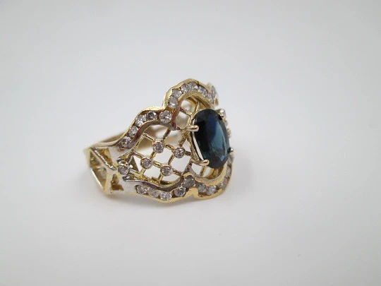 Women's openwork ring. 18 karat yellow gold, diamonds and sapphire. Europe