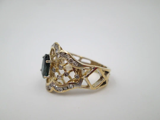 Women's openwork ring. 18 karat yellow gold, diamonds and sapphire. Europe